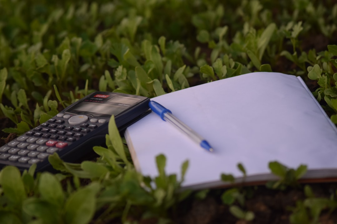 blue-ballpoint-pen-on-paper-beside-calculator-jlw-t4lijcw